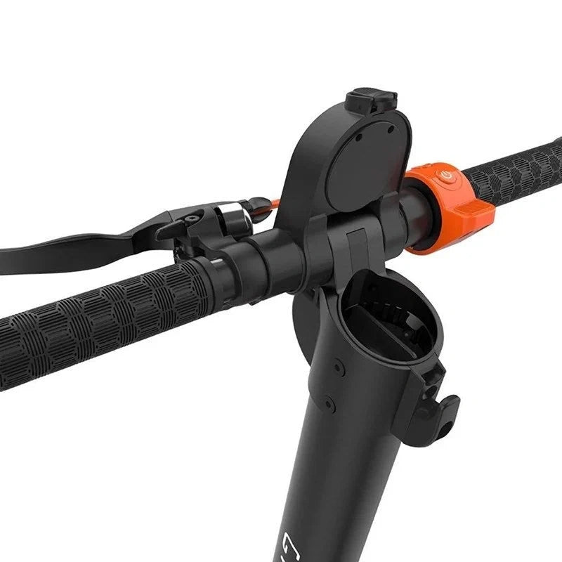Close-up of a black and orange archery bow nocking block on a white background