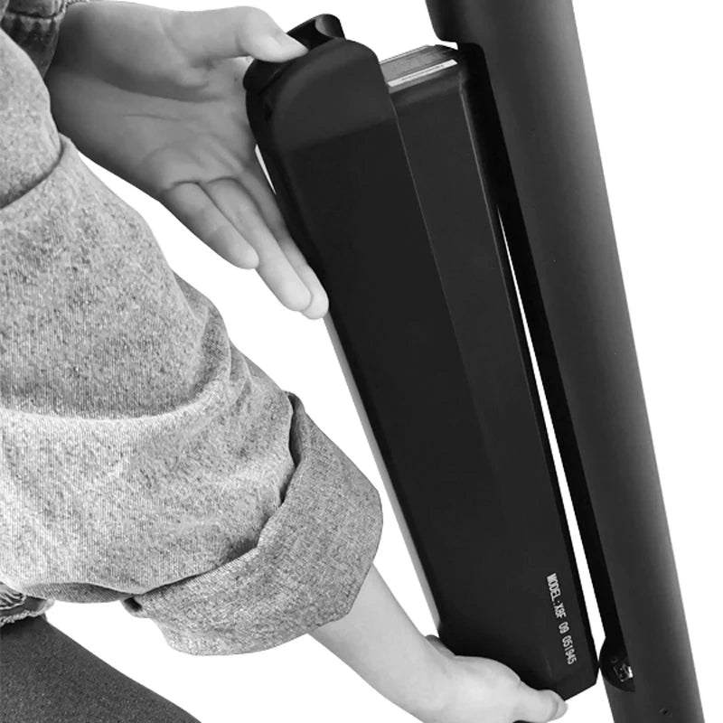 Person adjusting a black chair with a white background