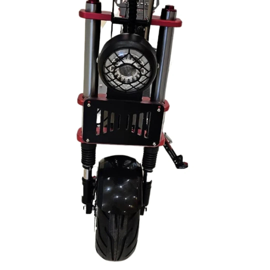 Black and red scooter with a large front wheel on a white background