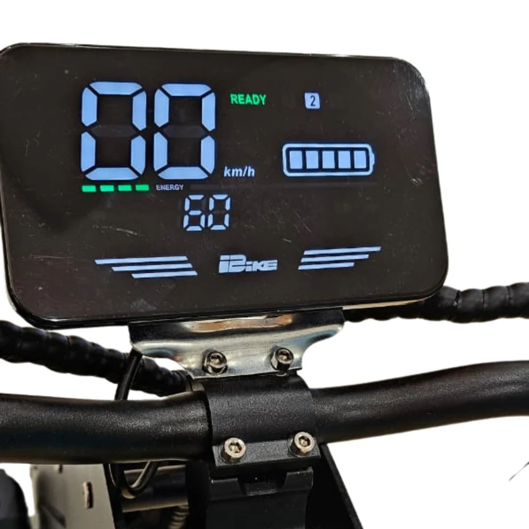 Digital display on a bicycle handlebar with battery indicator and other icons.