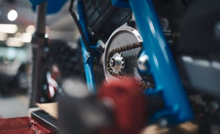 Close-up of a bicycle chain and gear system with blurred background