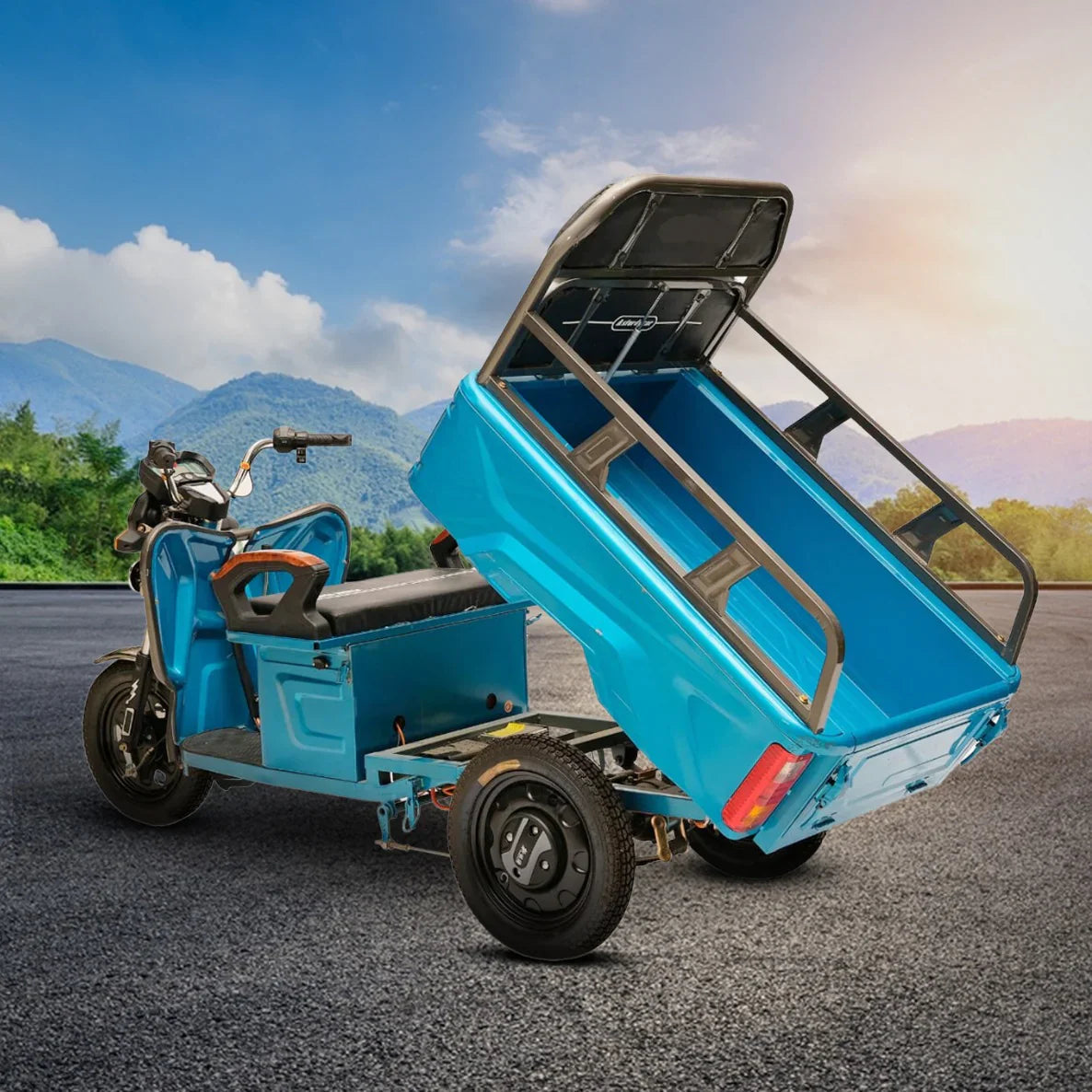 Blue three-wheeled vehicle with an open cargo bed on a road with mountains in the background