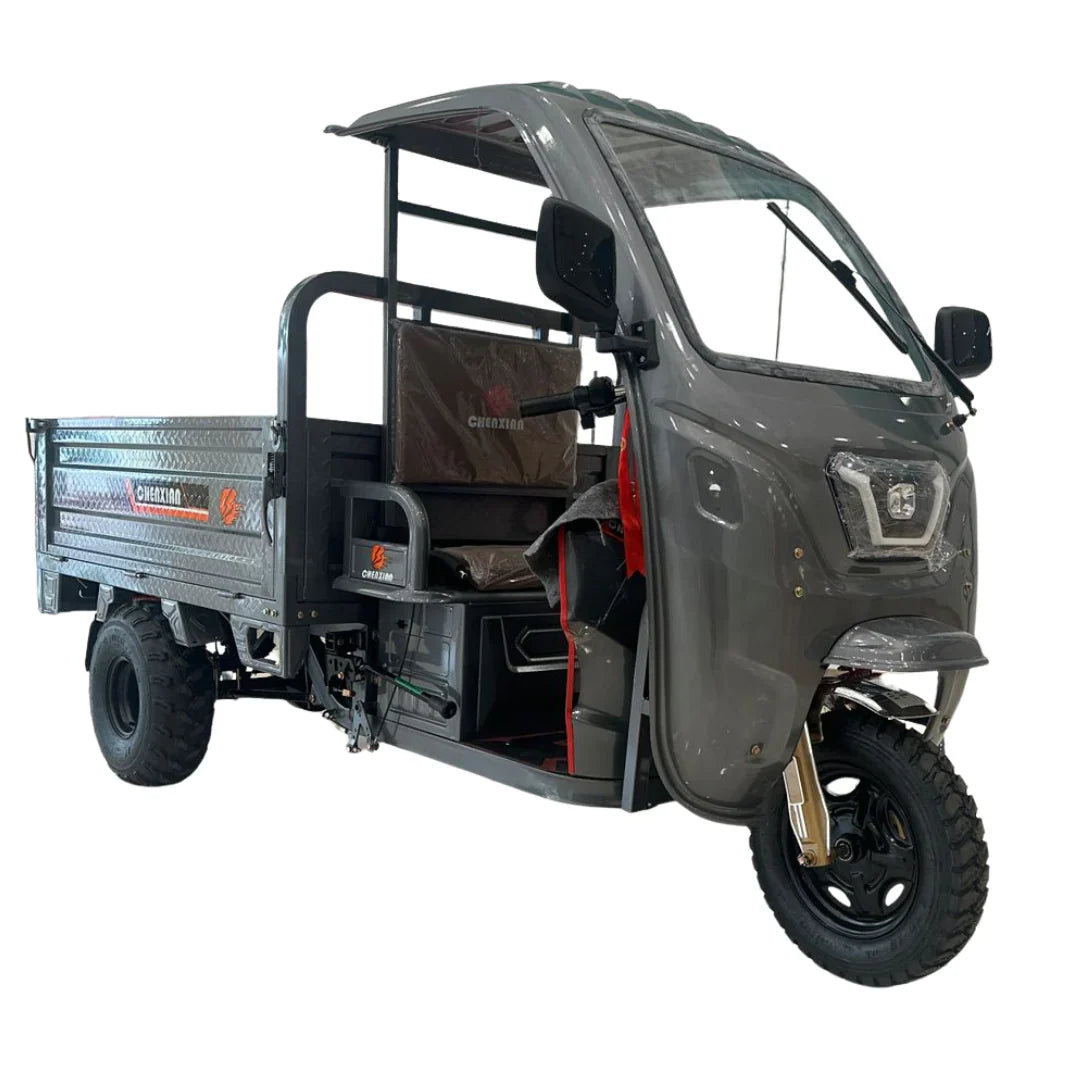 Three-wheeled motor vehicle with a cargo bed on a white background