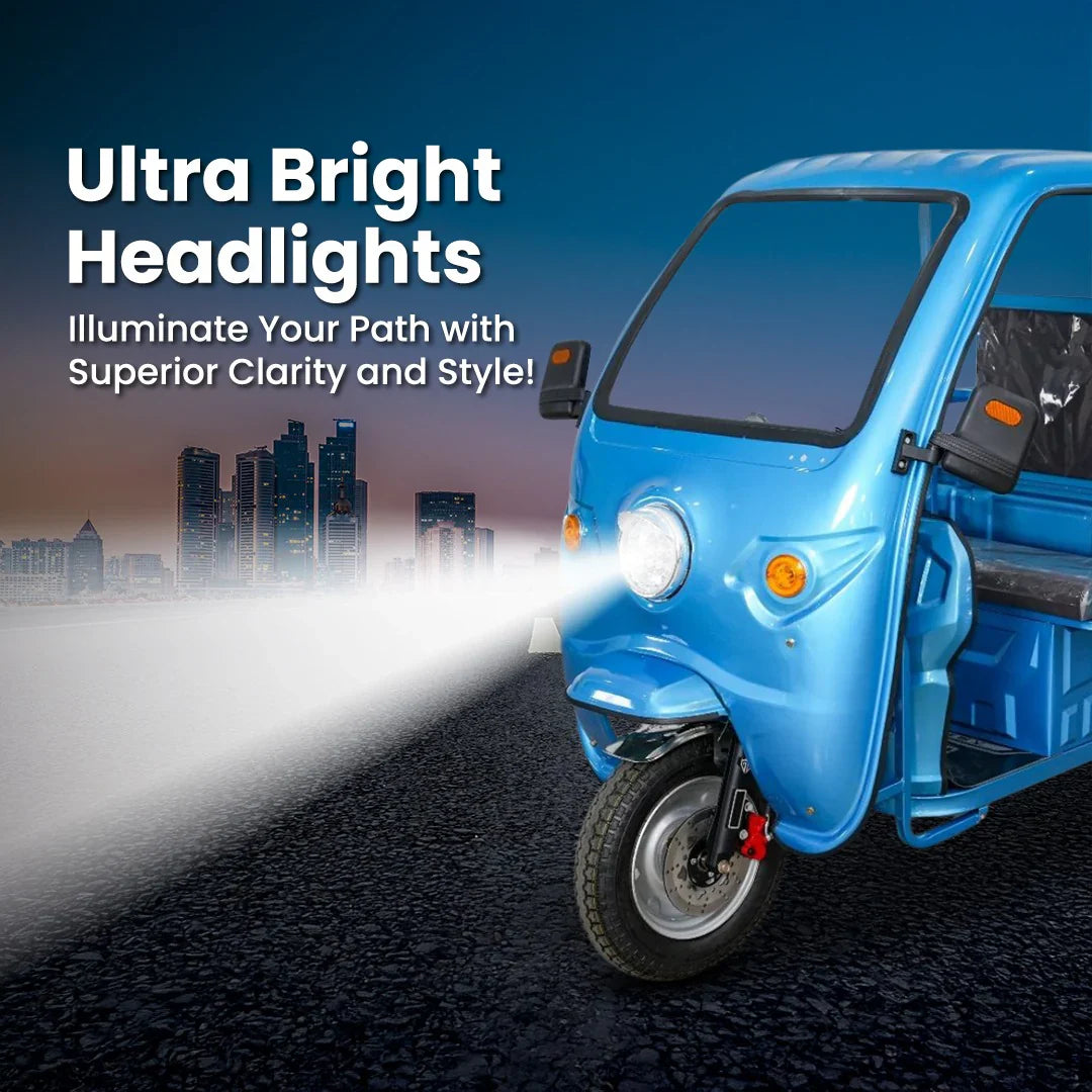 Blue three-wheeled vehicle with ultra bright headlights on a road at night.