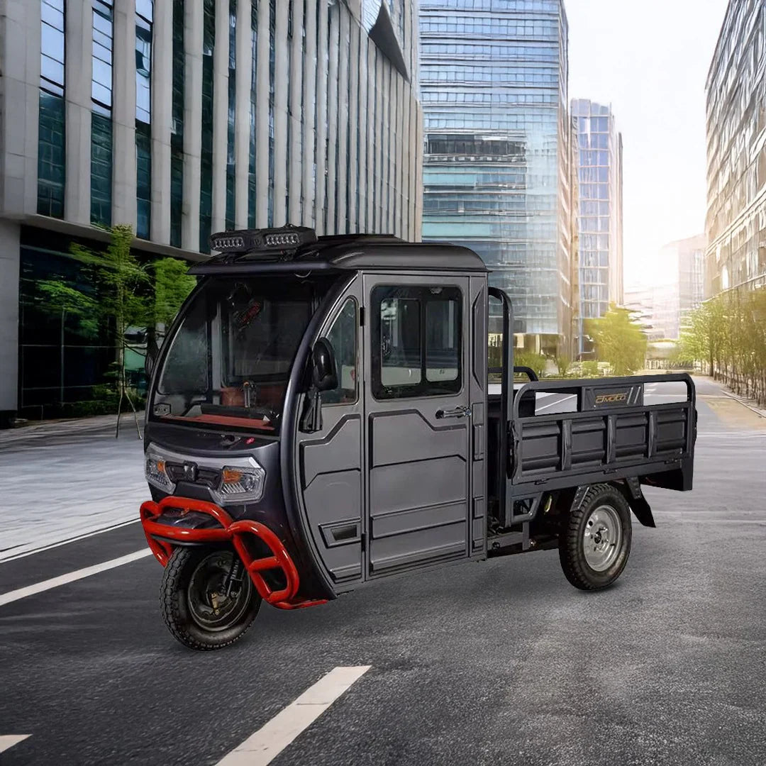 Three-wheeled vehicle with a cargo bed on an urban street