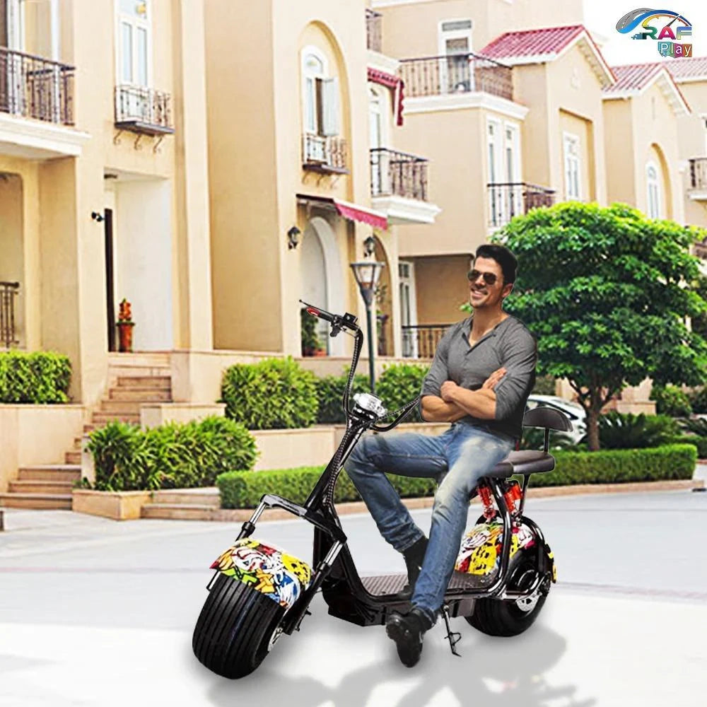 Man sitting on a black electric scooter with colorful fenders in front of a residential building.