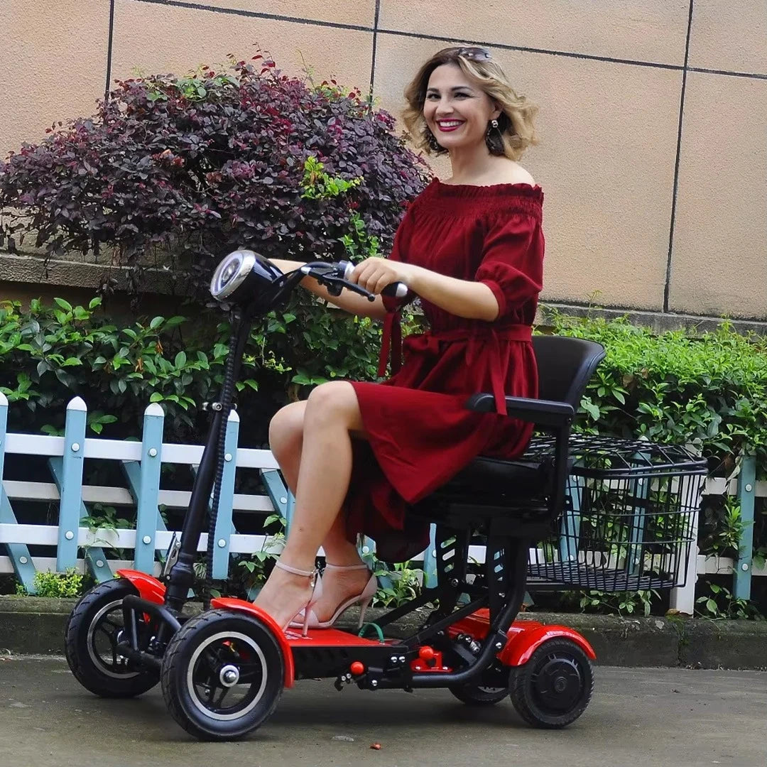 Woman in a red dress sitting on a mobility scooter outdoors.