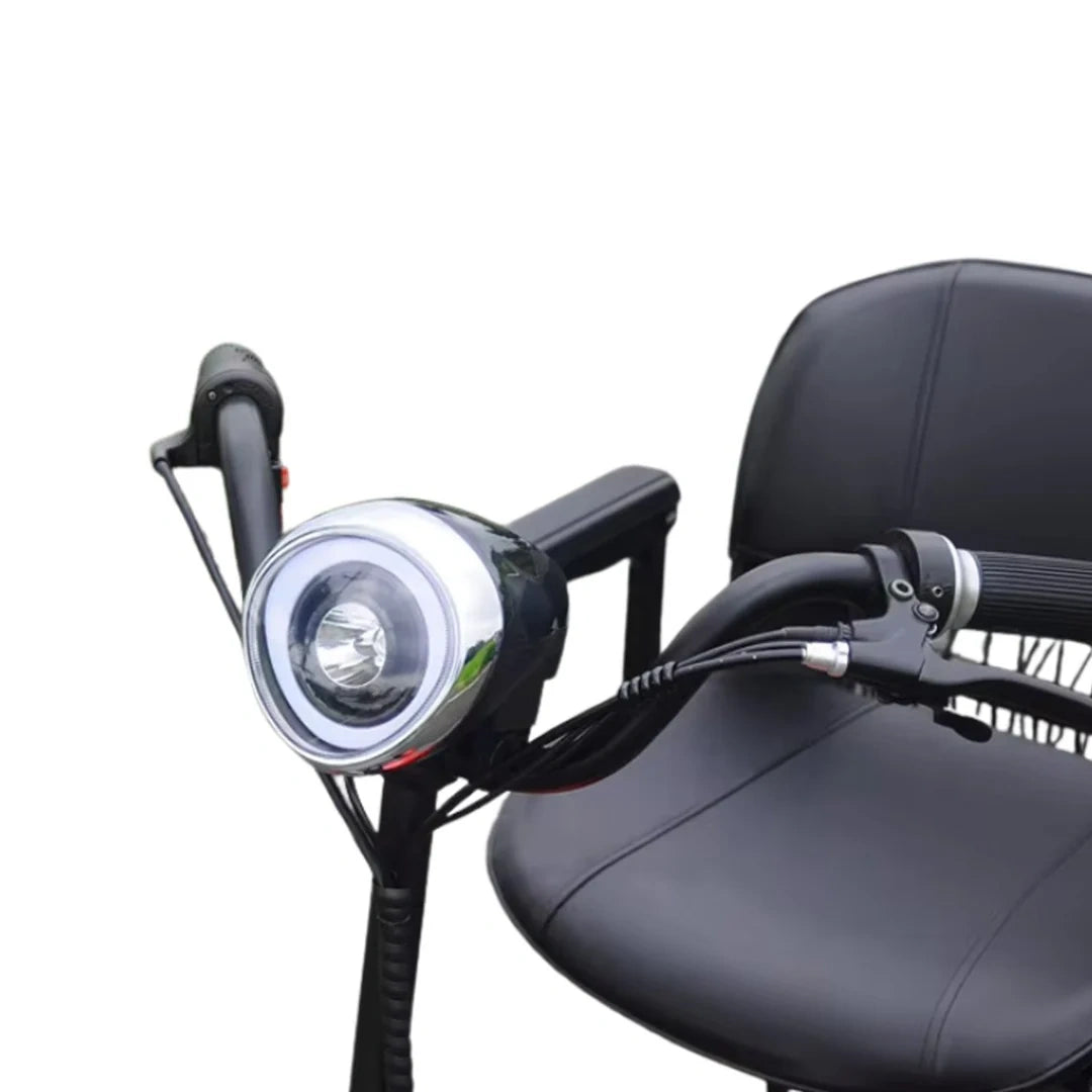 Close-up of a motorcycle seat and handlebar with a headlight on a white background