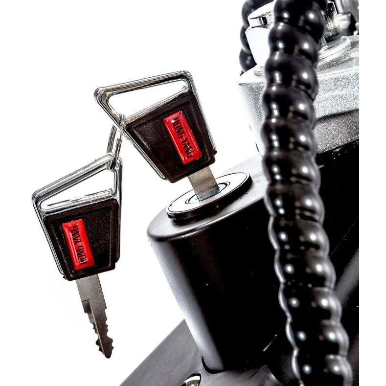 Close-up of a car ignition switch with two keys inserted, one red labeled 'HOLD', on a white background.