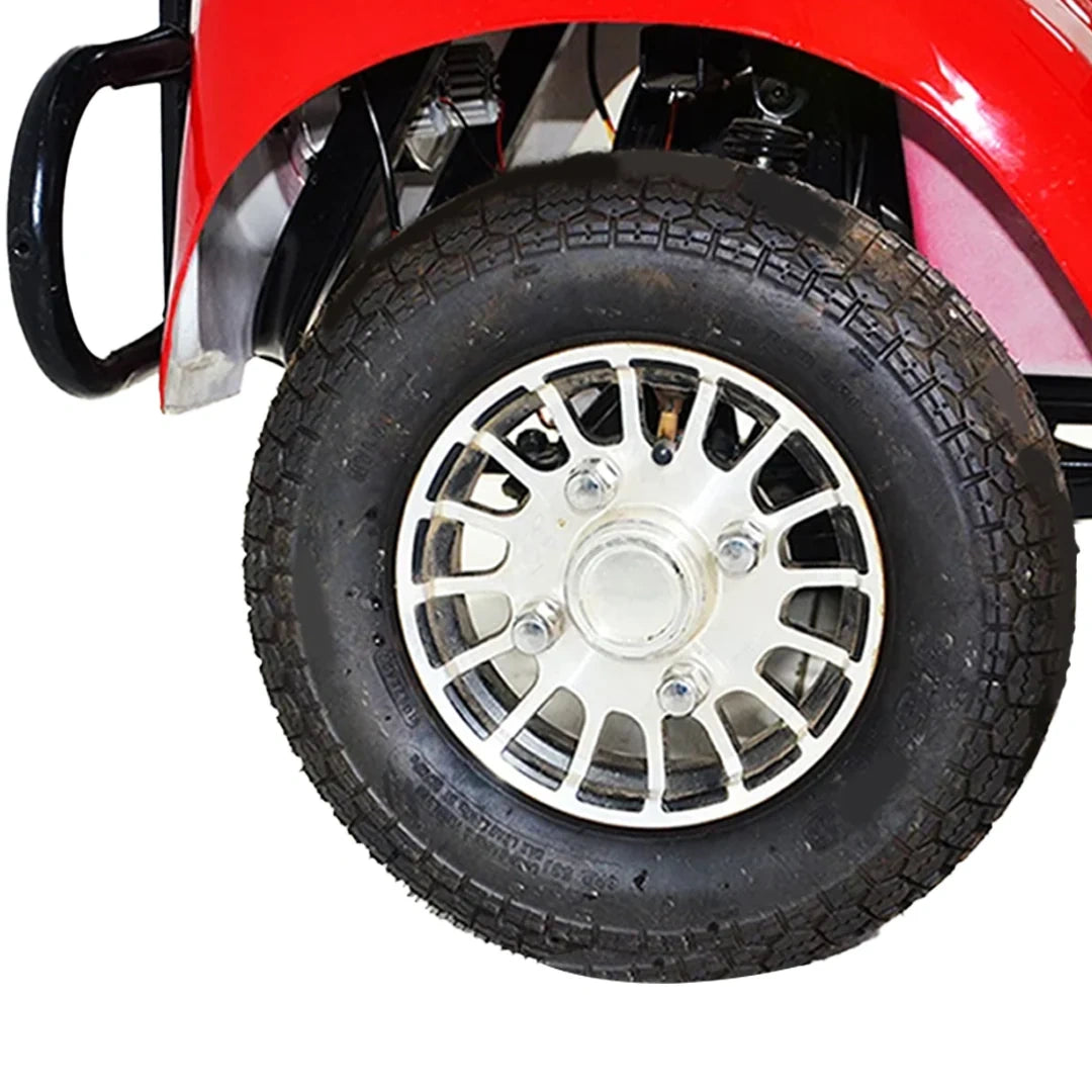 Close-up of a black tire with a silver rim on a red vehicle.