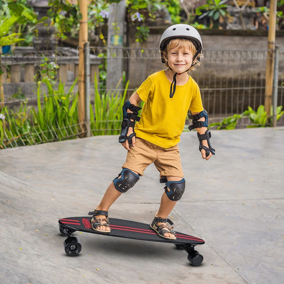 Child on a skateboard wearing protective gear in an outdoor setting