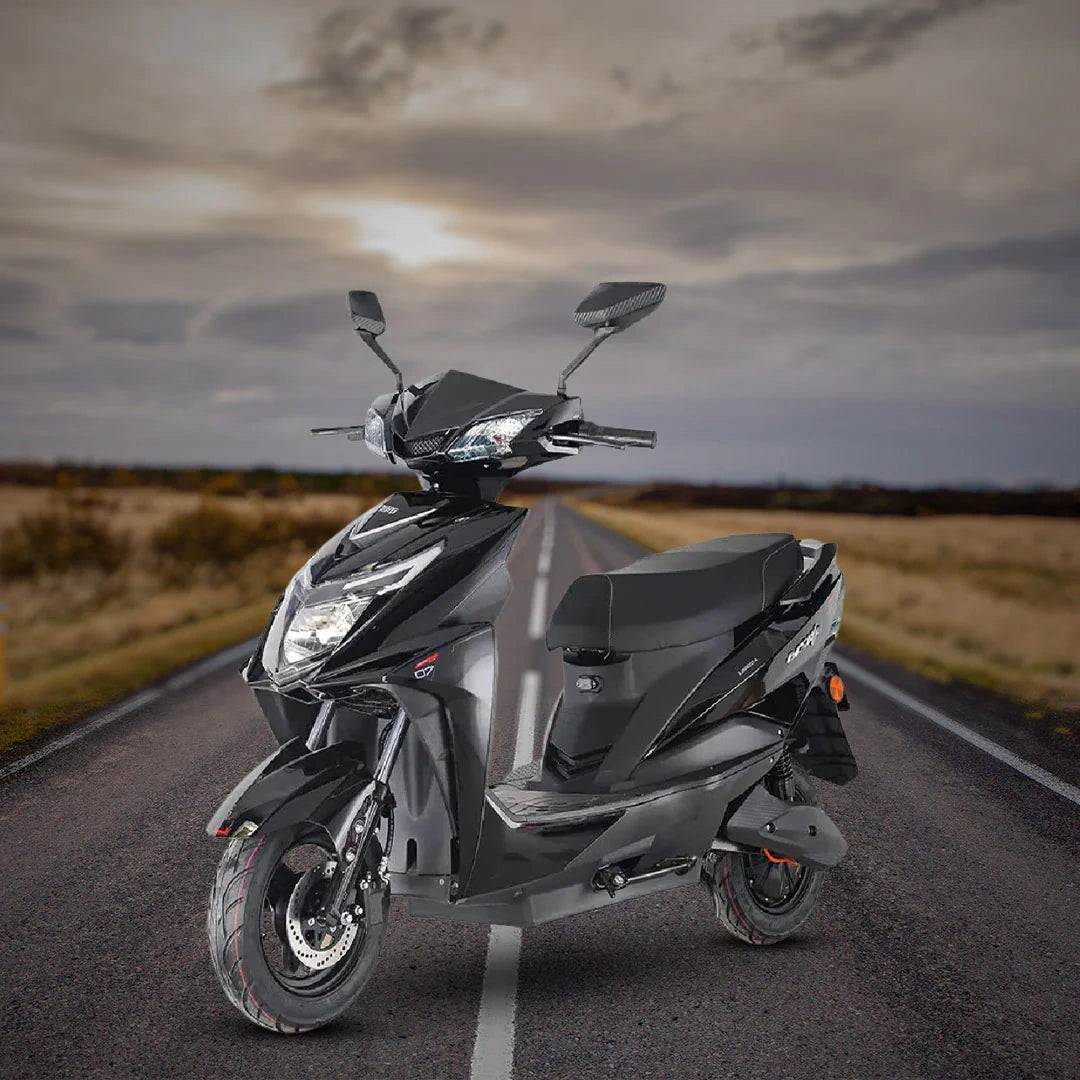 Gray scooter on a road with a cloudy sky