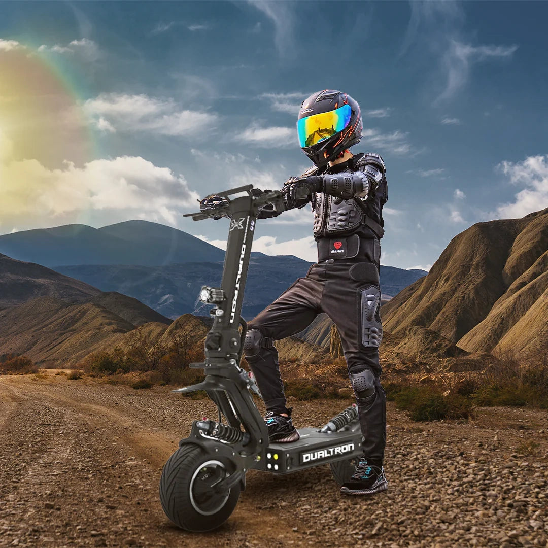 Person on a dualtron electric scooter in a mountainous landscape