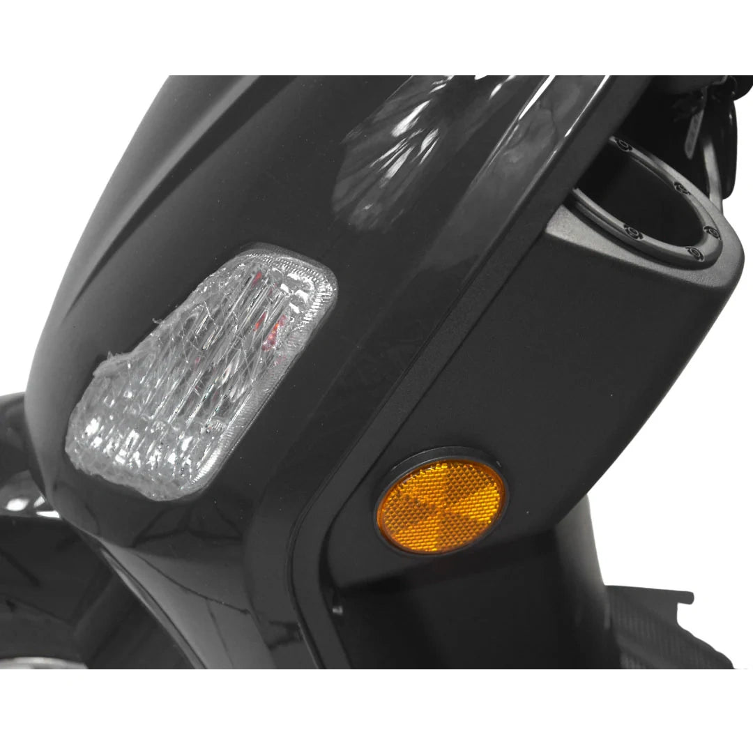 Close-up of a motorcycle headlight and turn signal on a white background