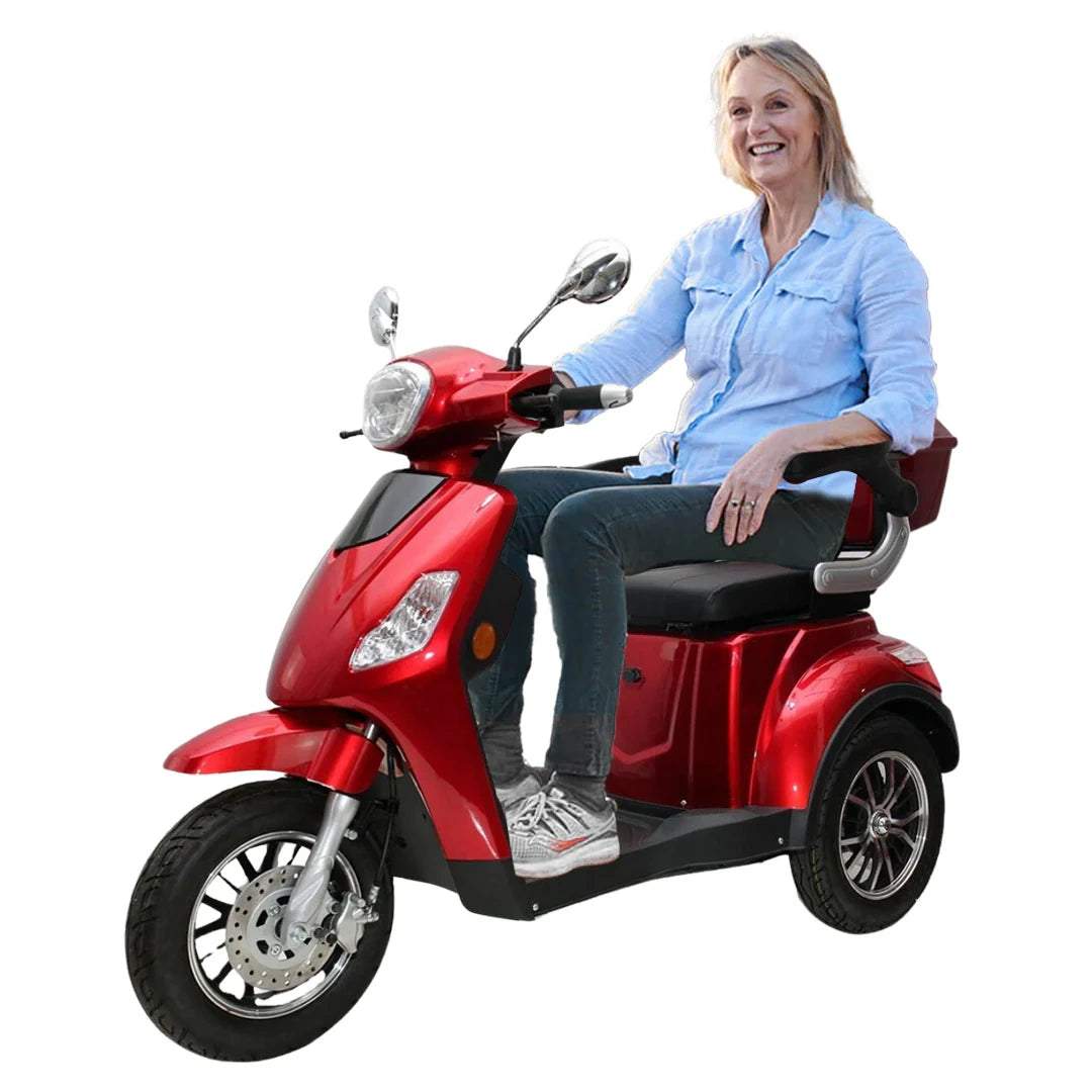 Woman sitting on a red mobility scooter against a white background