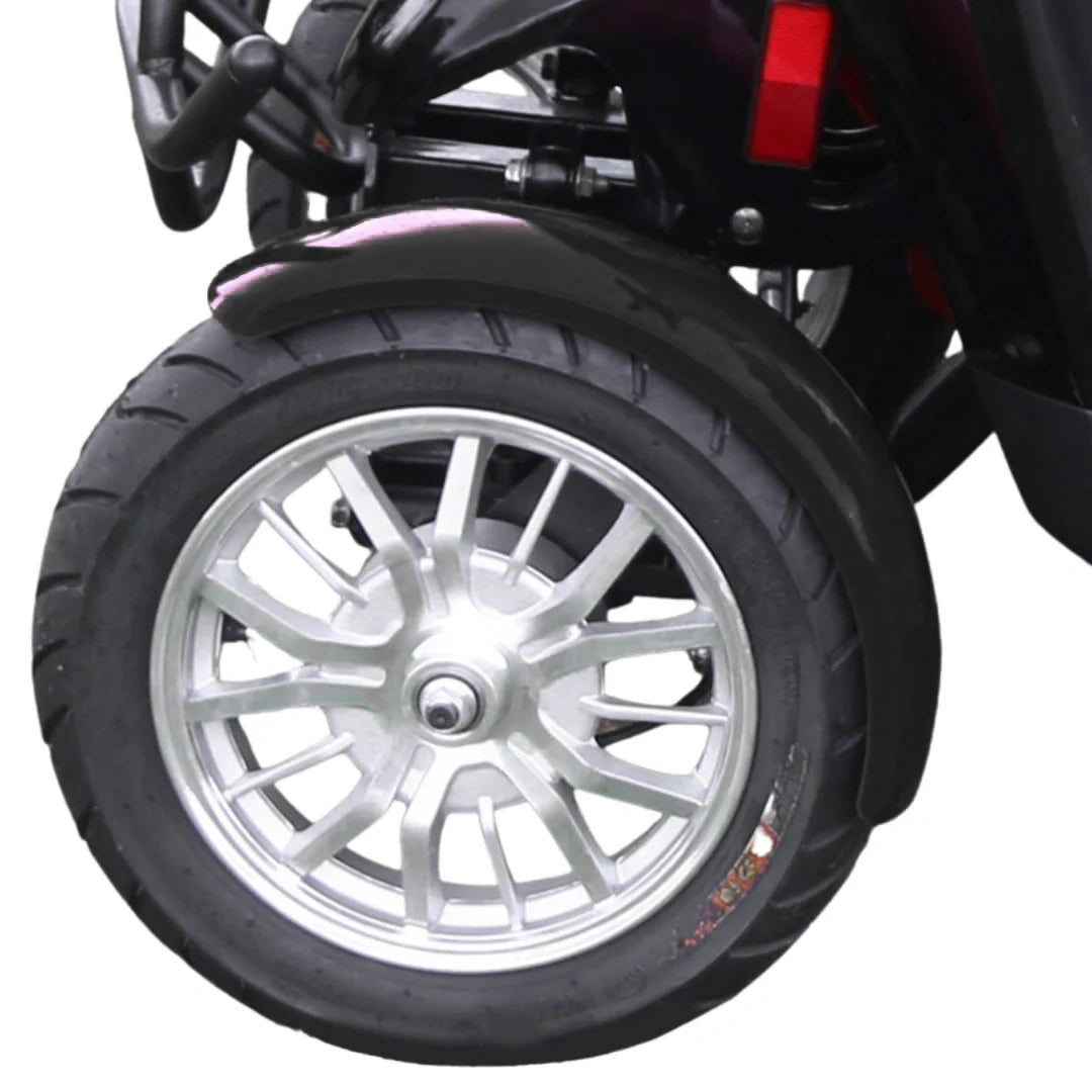 Close-up of a wheel with a black tire and silver rim on a white background