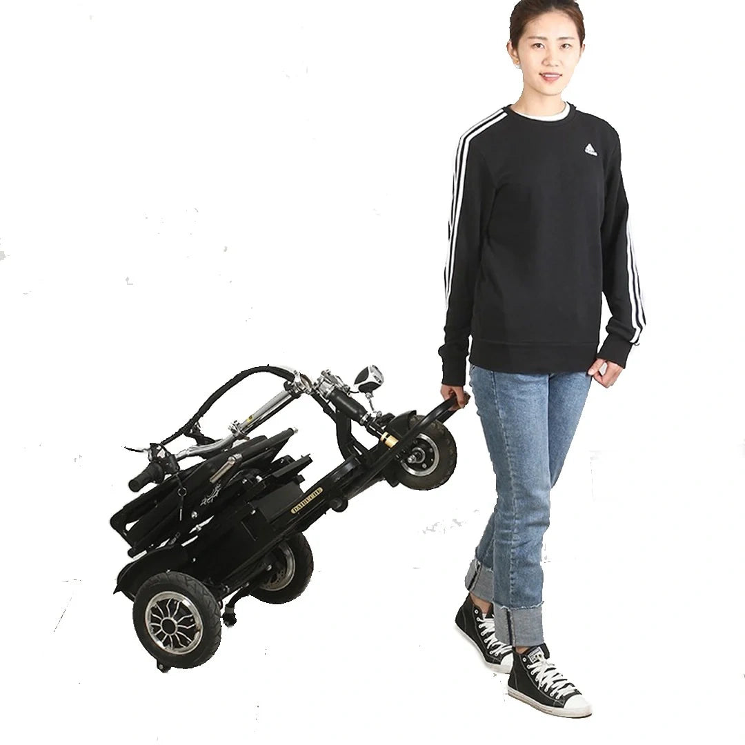 Person holding a folded electric scooter on a white background