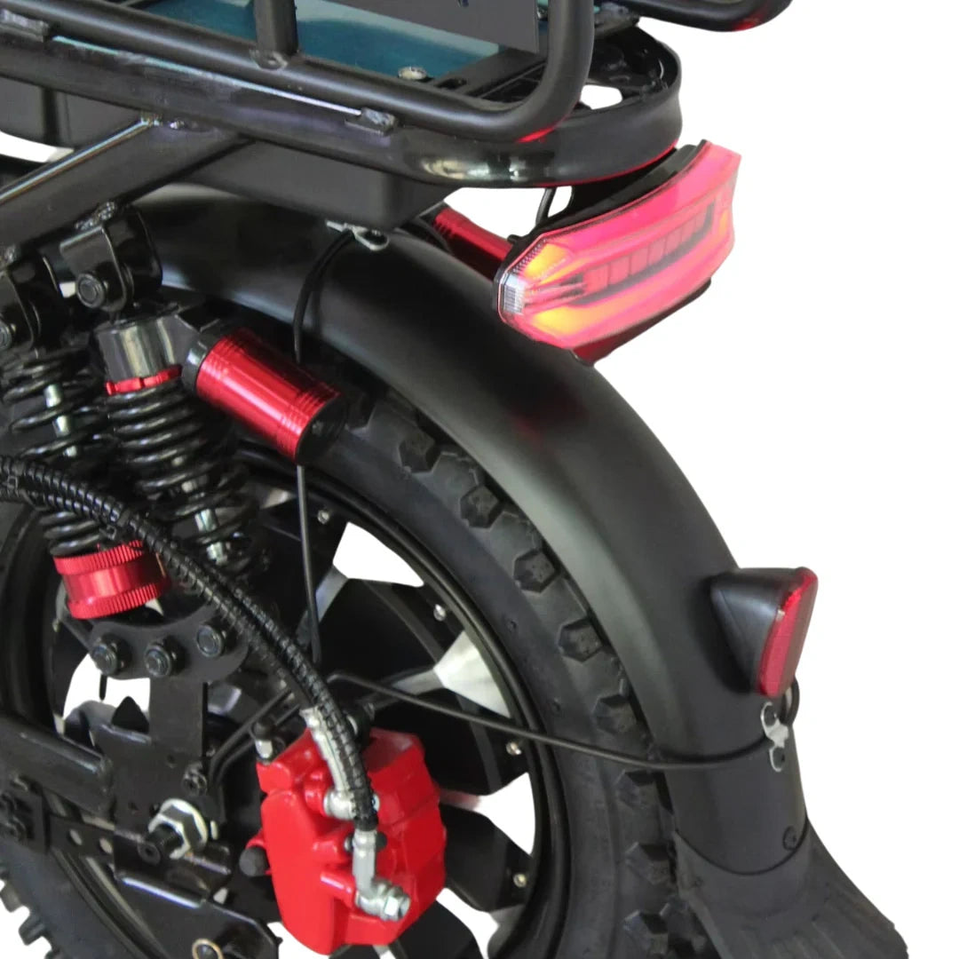 Close-up of a motorcycle's rear wheel and suspension system on a white background