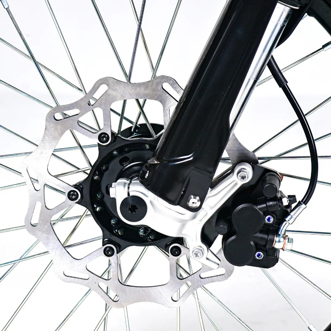 Close-up of a bicycle wheel with disc brake system on a white background