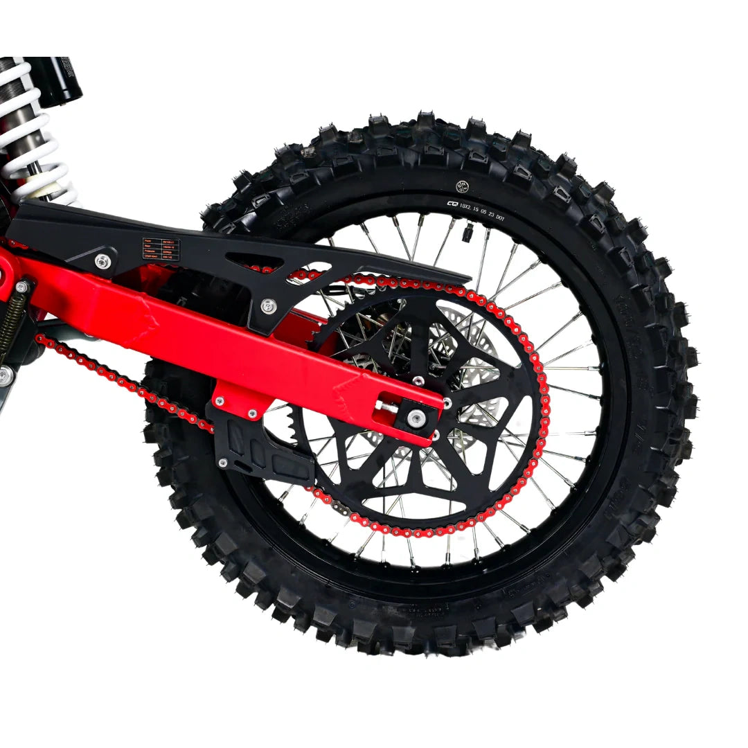 Close-up of a dirt bike wheel with red chain on a white background