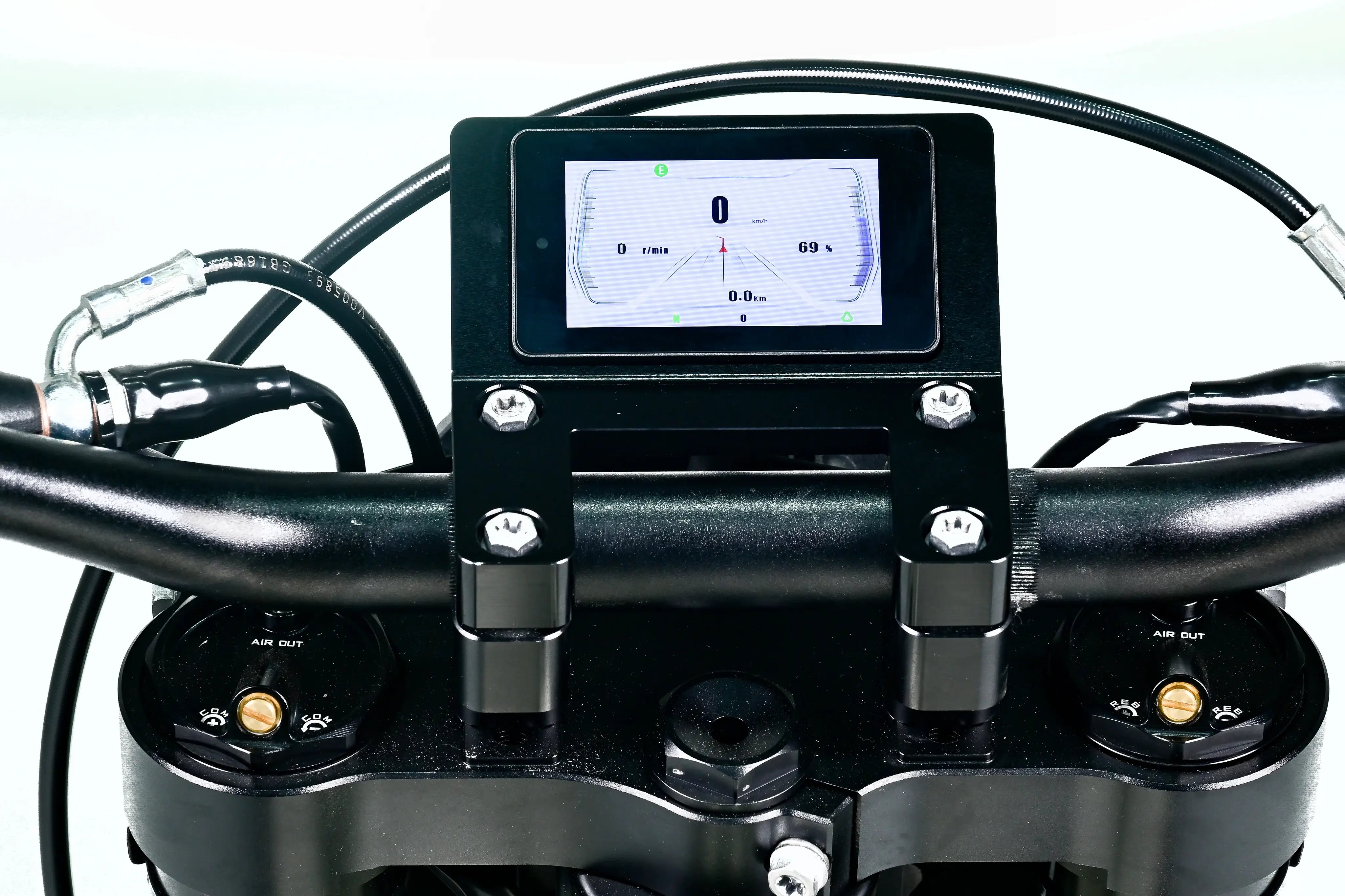 Close-up of a motorcycle handlebar with digital display and control buttons.