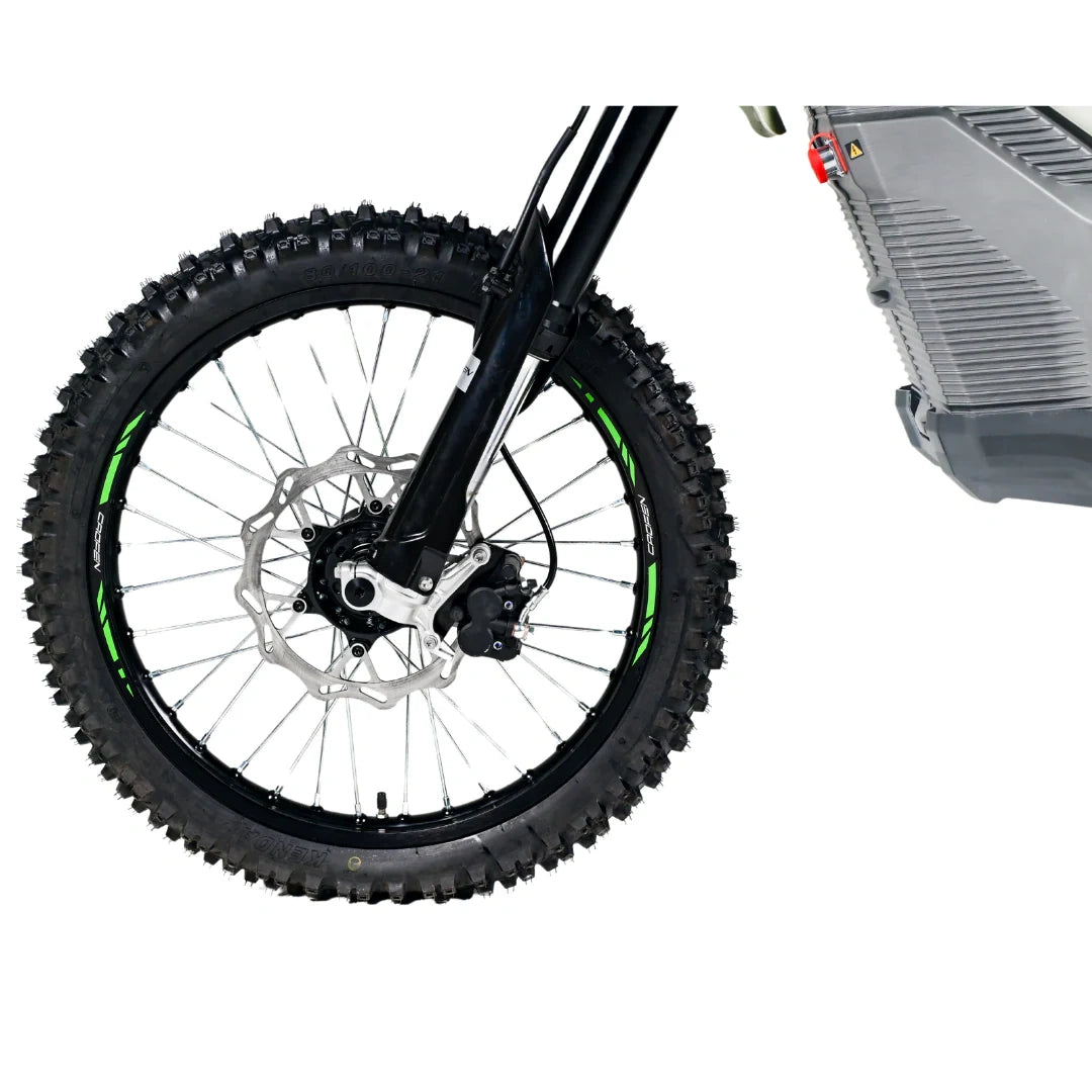 Close-up of a bicycle wheel with knobby tires and a battery pack on a white background