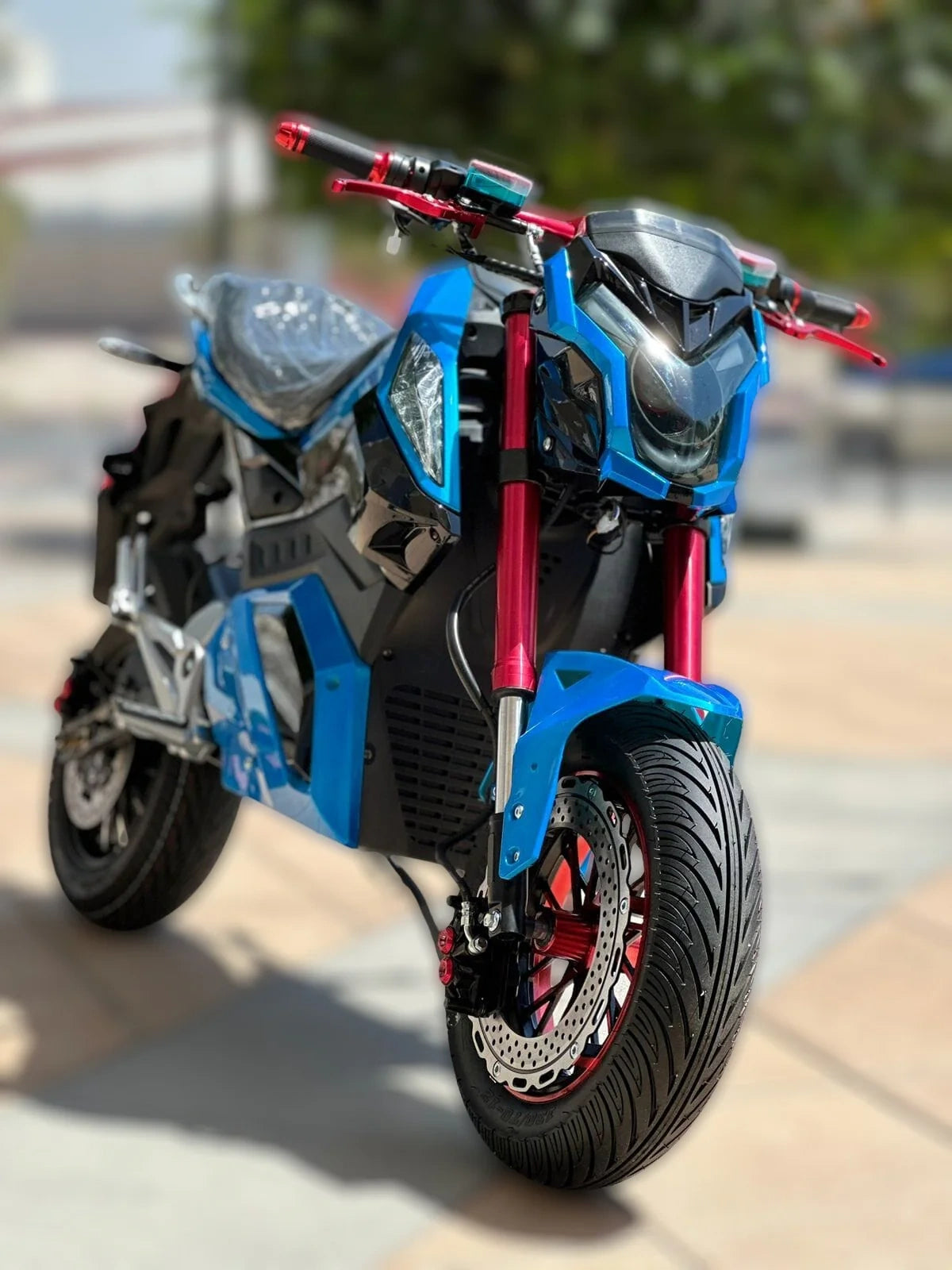 Blue and black motorcycle with red accents on a blurred background