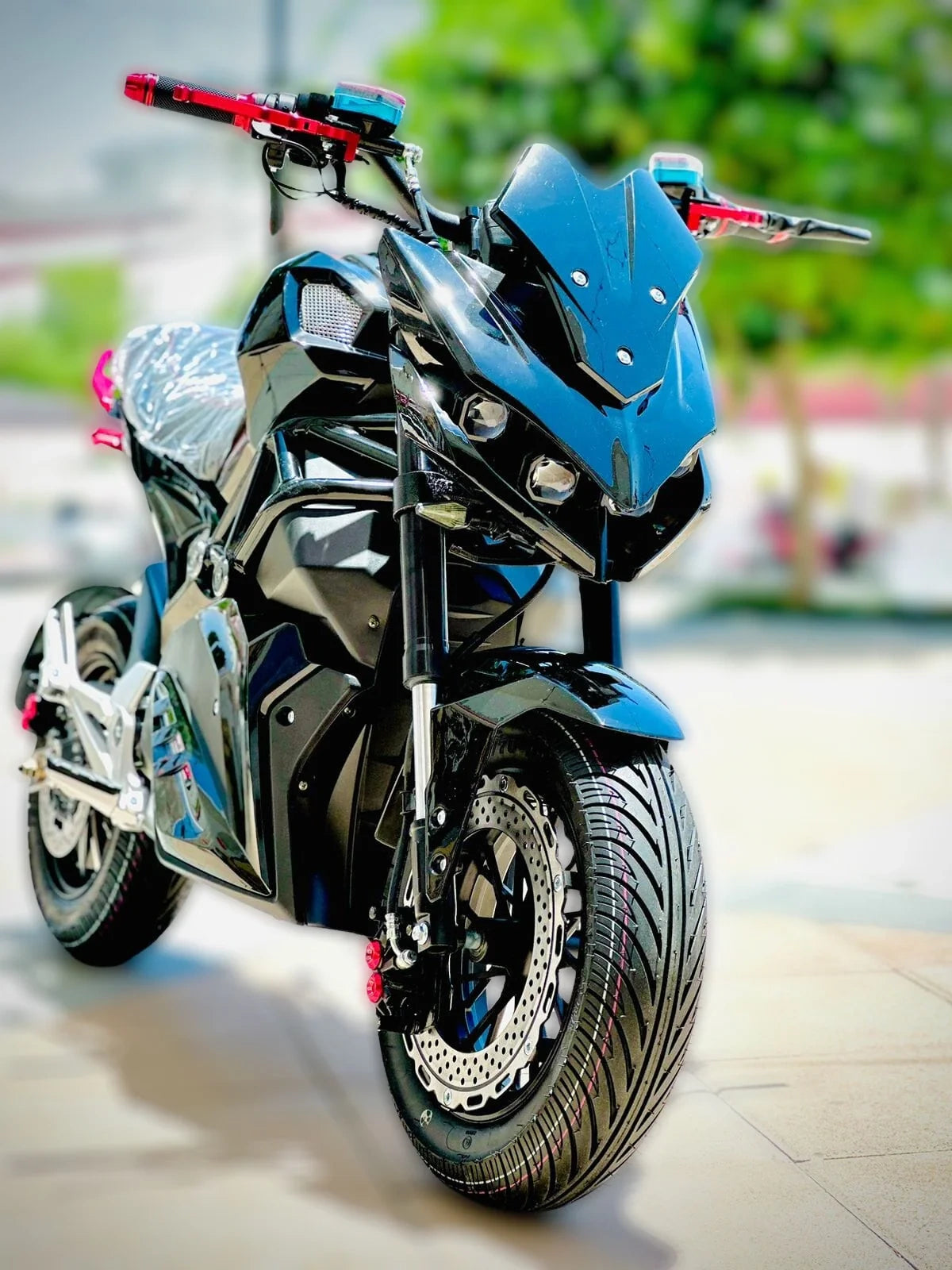 Blue and black motorcycle with red accents on a blurred background