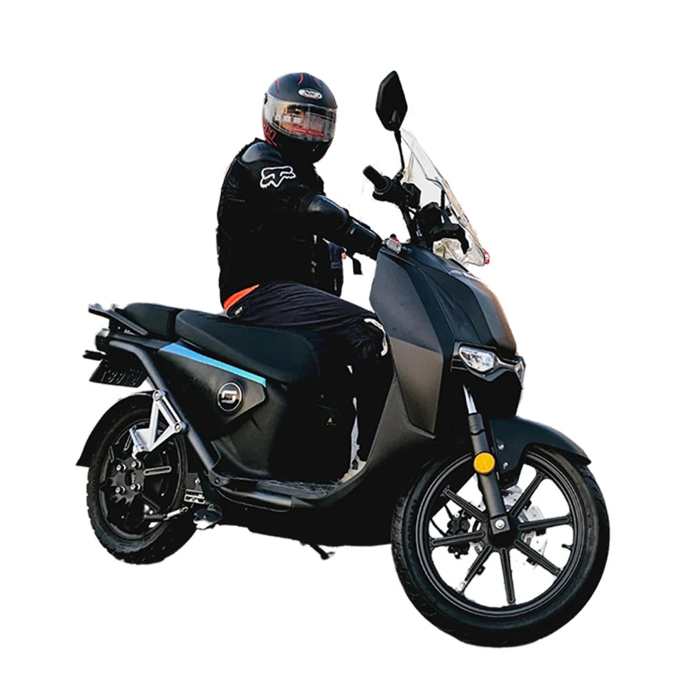 Person sitting on a black scooter with a white background