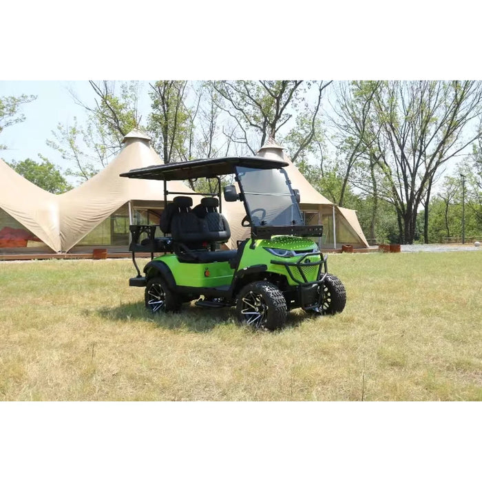Green golf cart on grass with tents and trees in the background