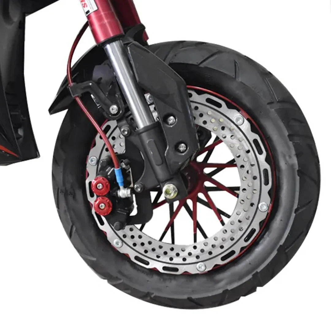 Close-up of a motorcycle wheel with disc brake and suspension on a white background