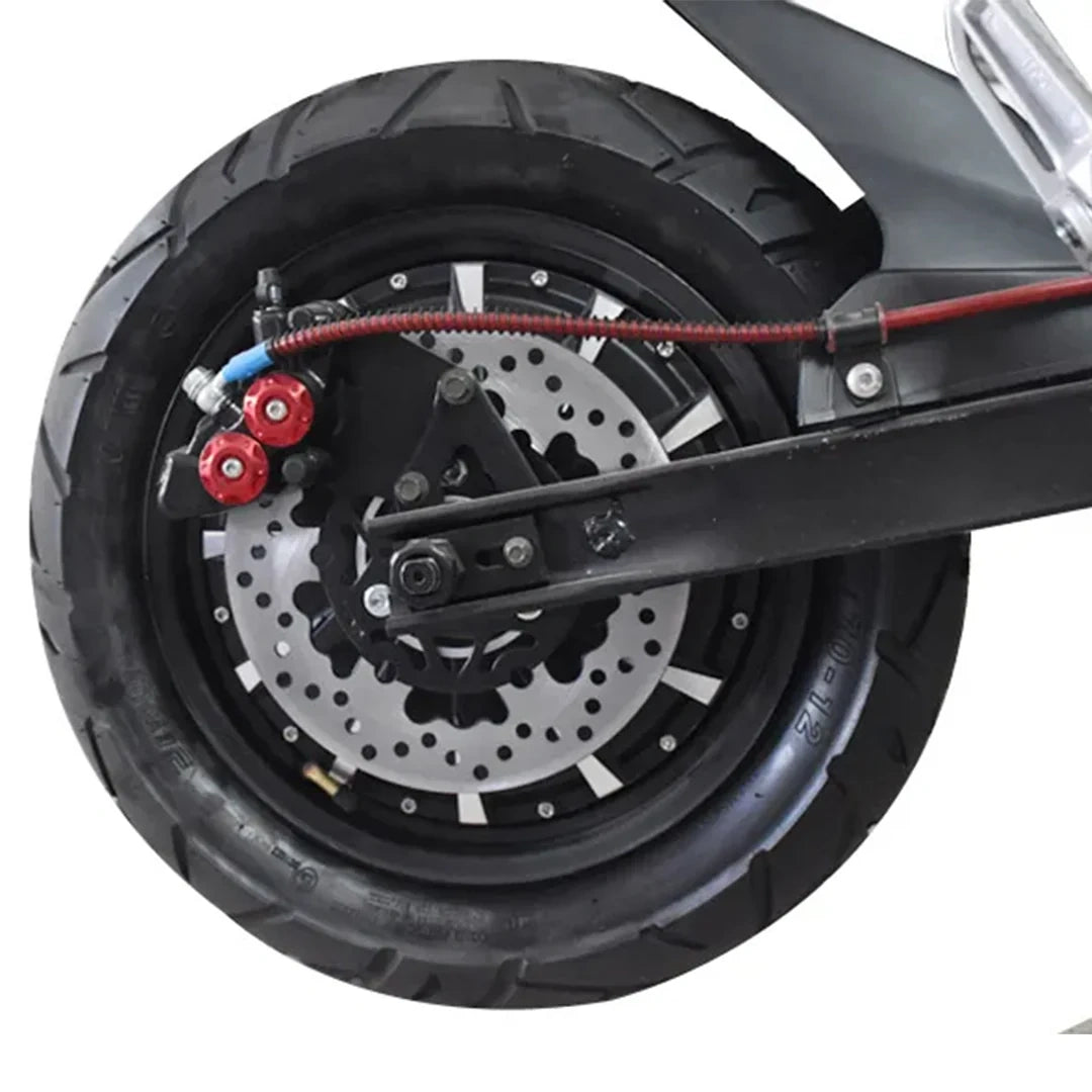 Close-up of a motorcycle wheel with suspension and brake components on a white background