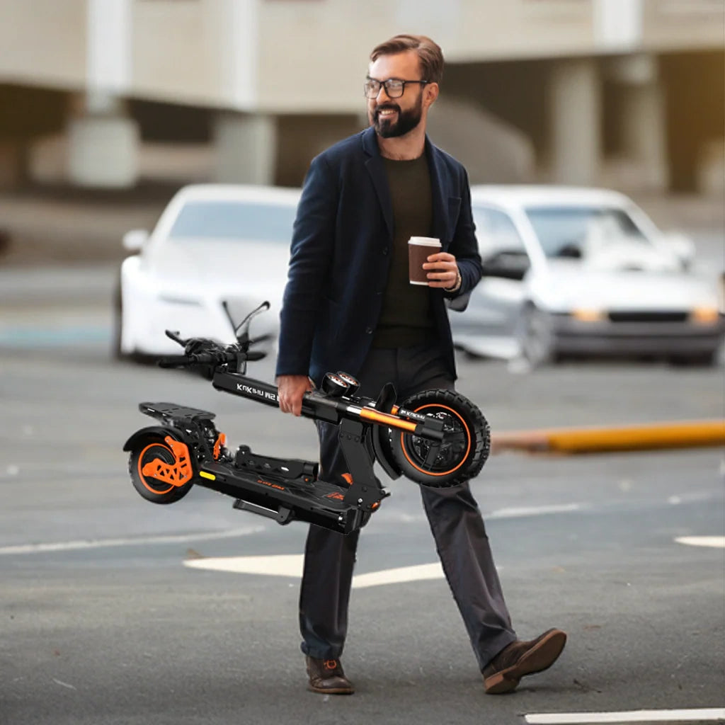 Man carrying a folded electric scooter on a city street.