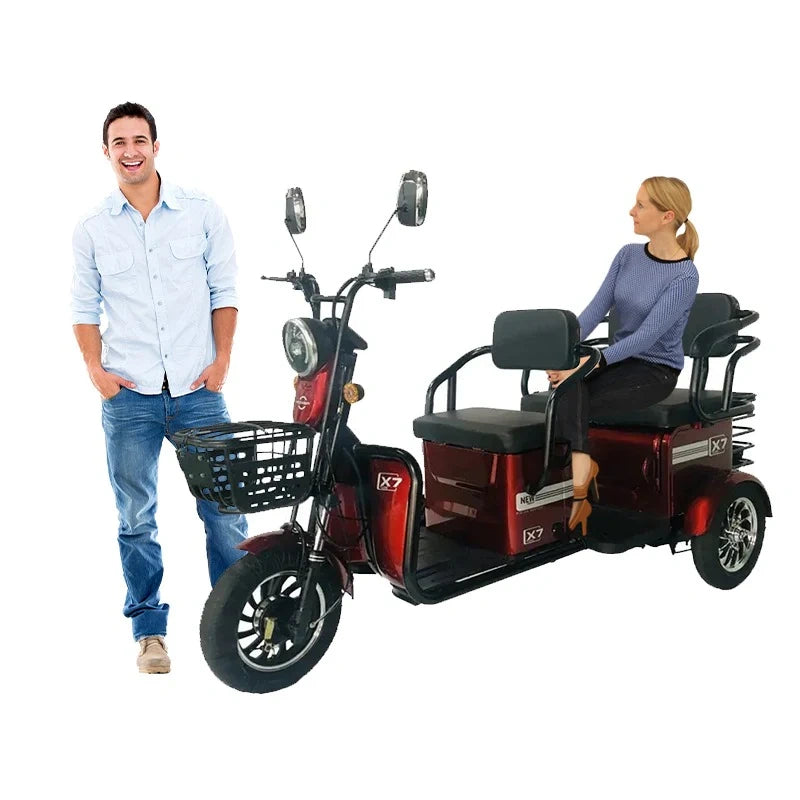 Electric tricycle with a man standing next to it and a woman sitting on it, on a white background.