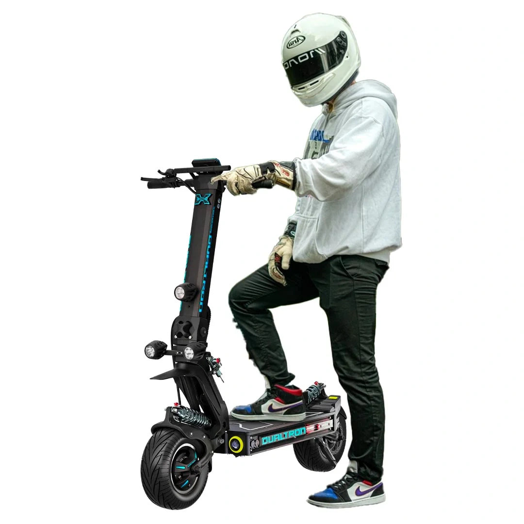 Person on a scooter with protective gear on a white background