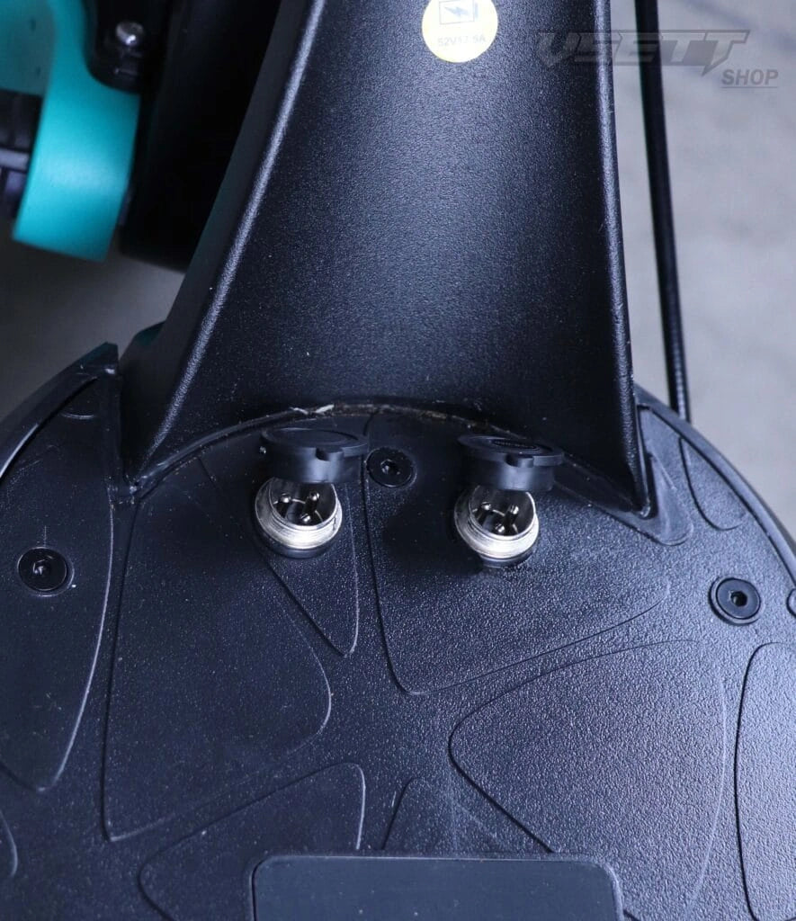 Close-up of a black motorcycle seat with visible branding on a blurred background