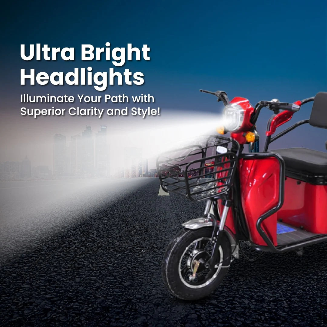 Red electric scooter with ultra bright headlights on a dark road against a blue sky.