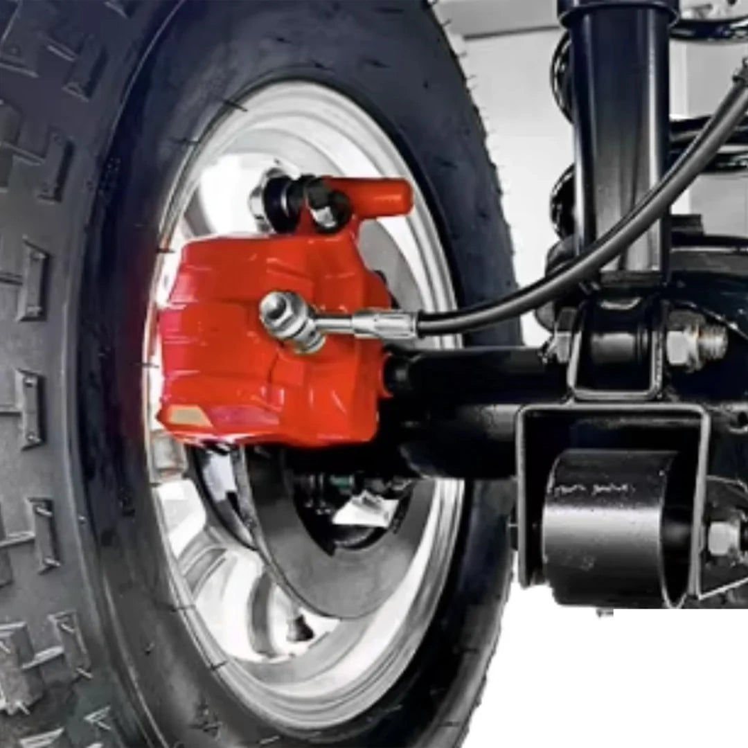 Close-up of a motorcycle wheel with red brake caliper and black tire.