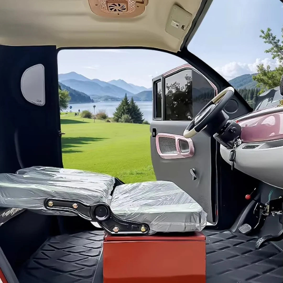Car interior with a folded scooter on a stand, open car door showing a scenic view.
