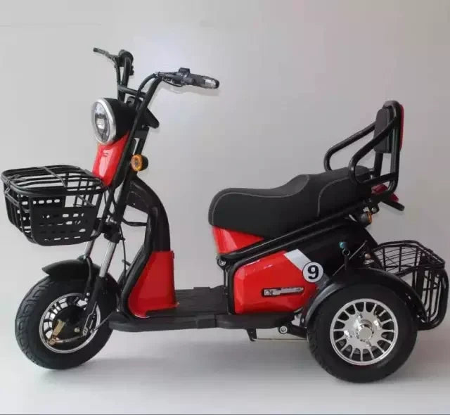 Red and black three-wheeled electric scooter with baskets on a white background