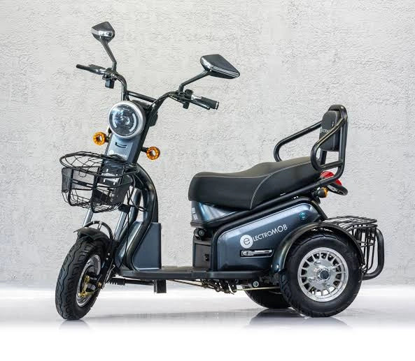 Three-wheeled electric scooter with basket on a light gray background
