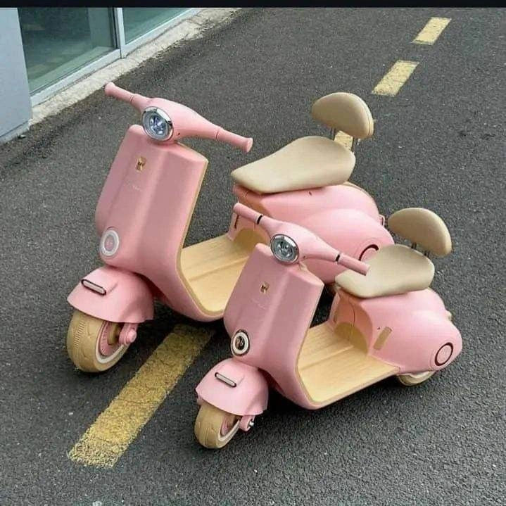 Pink children's scooter on a road