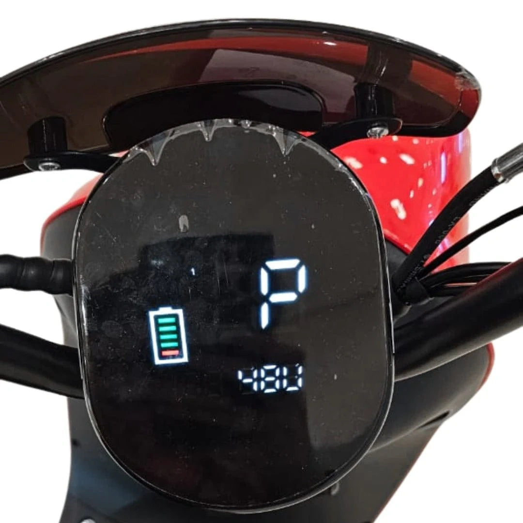 Close-up of a motorcycle digital display with a charging symbol and number '1' on a white background