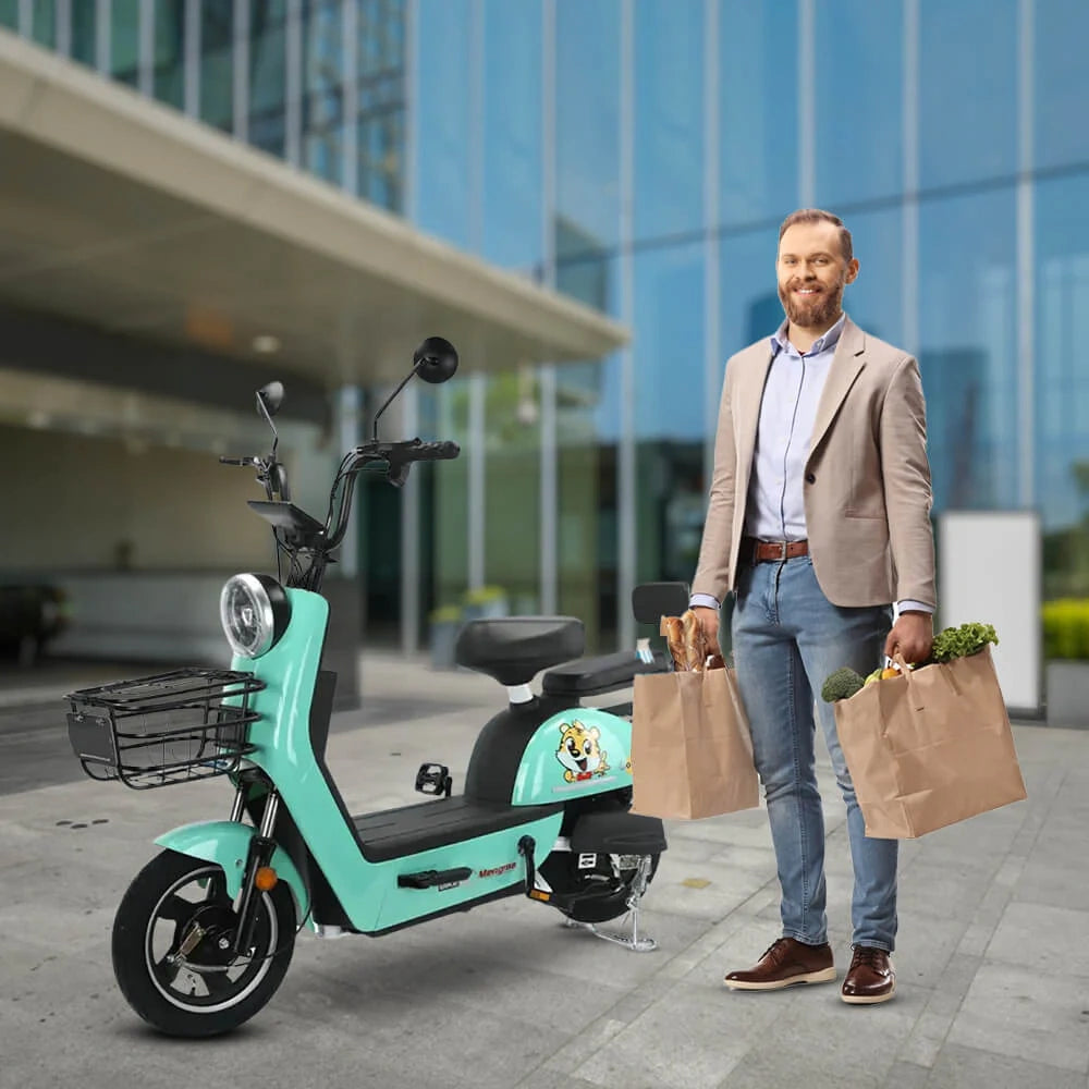 Man standing next to a teal electric scooter holding shopping bags in an urban setting.
