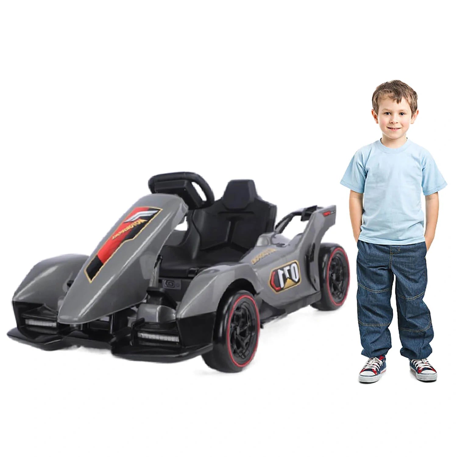 Child standing next to a toy race car on a white background