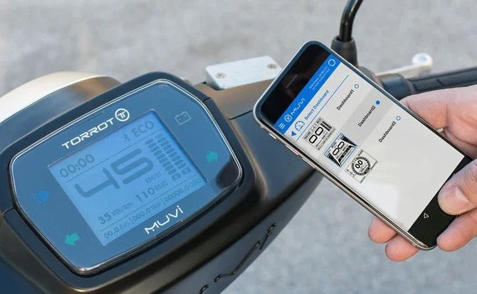 Motorcycle with digital display and smartphone showing app interface