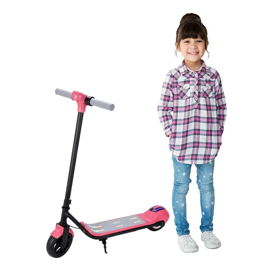 Child standing next to a pink scooter on a white background