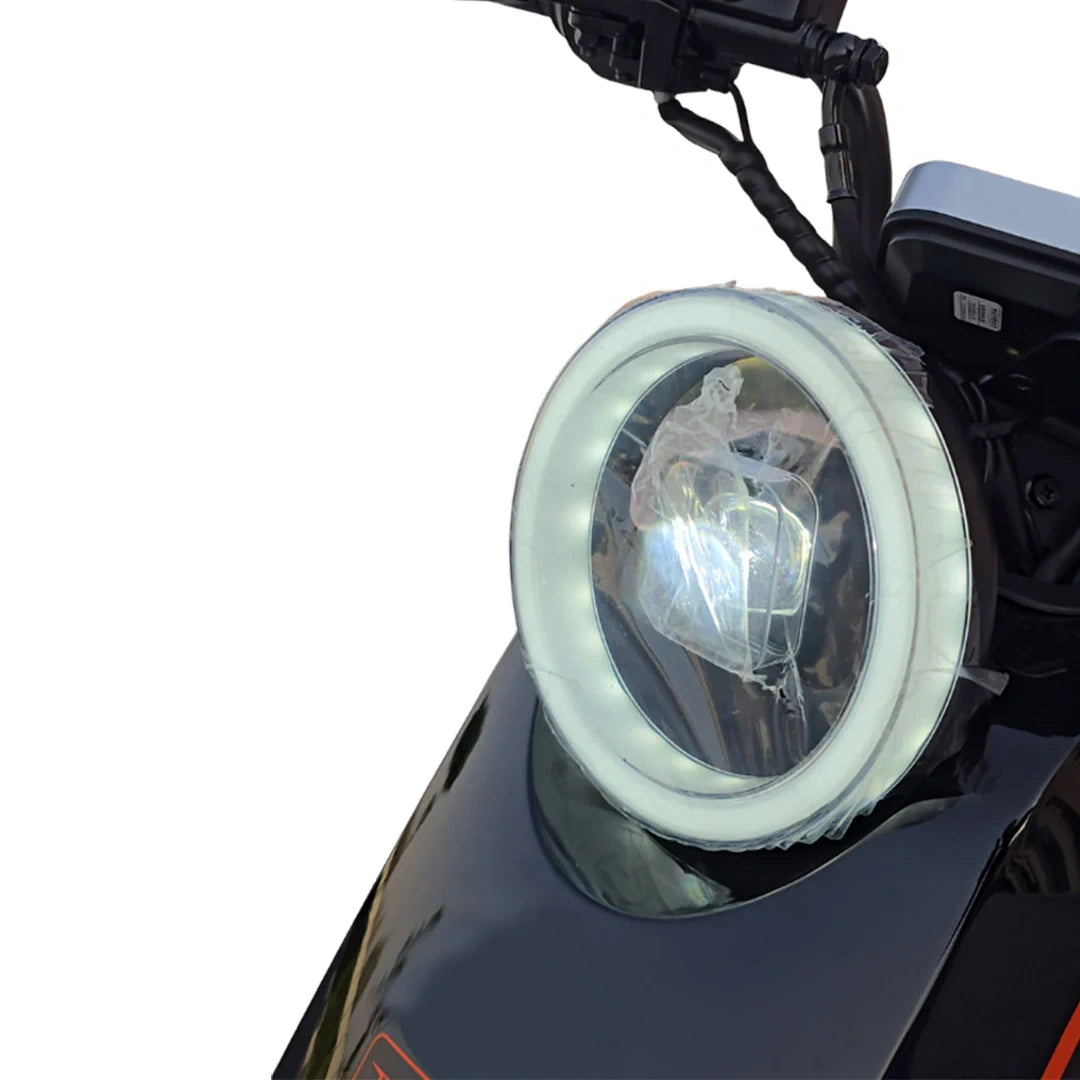 Motorcycle headlight with protective cover on a white background