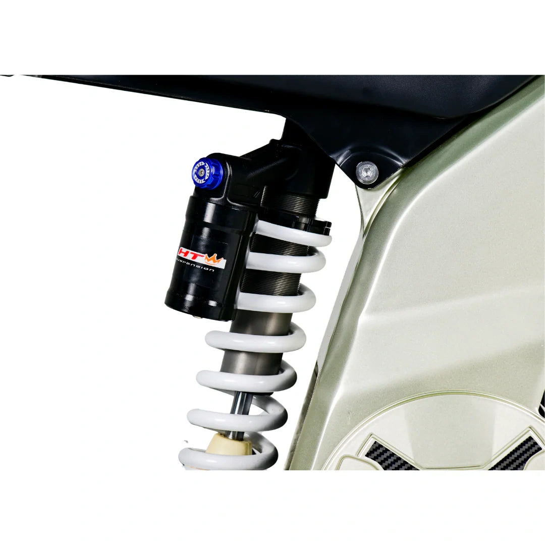 Close-up of a motorcycle shock absorber with a visible brand logo on a white background