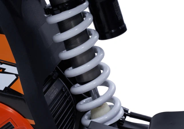 Close-up of a motorcycle suspension system with KTM branding.